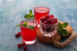 Glasses of fresh cranberry drink. Selective focus